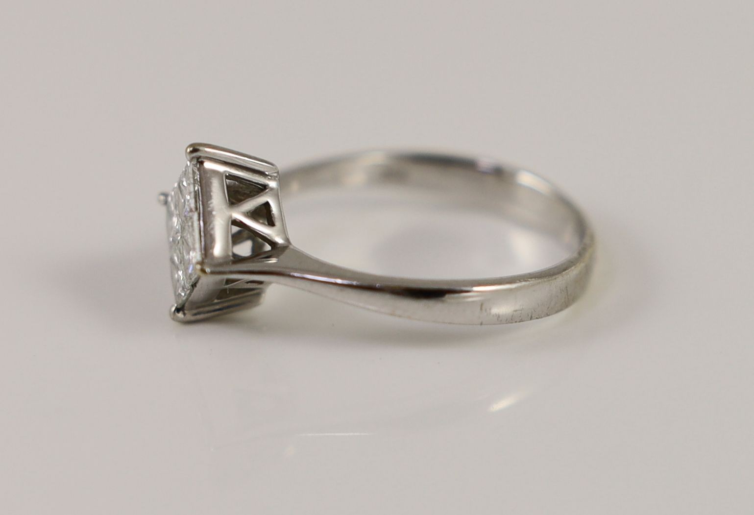 A modern 18k white gold and princess cut diamond set four stone cluster ring
